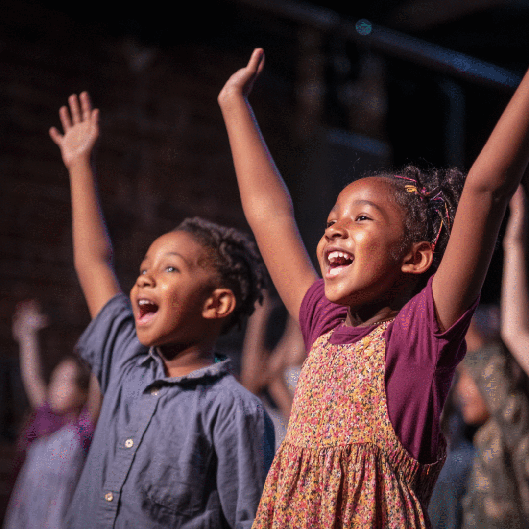 nalhall_happy_black_and_brown_children_on_stage_acting_in_a_t_000b0911-ab28-4b8c-be13-16ae42eba9e3_2